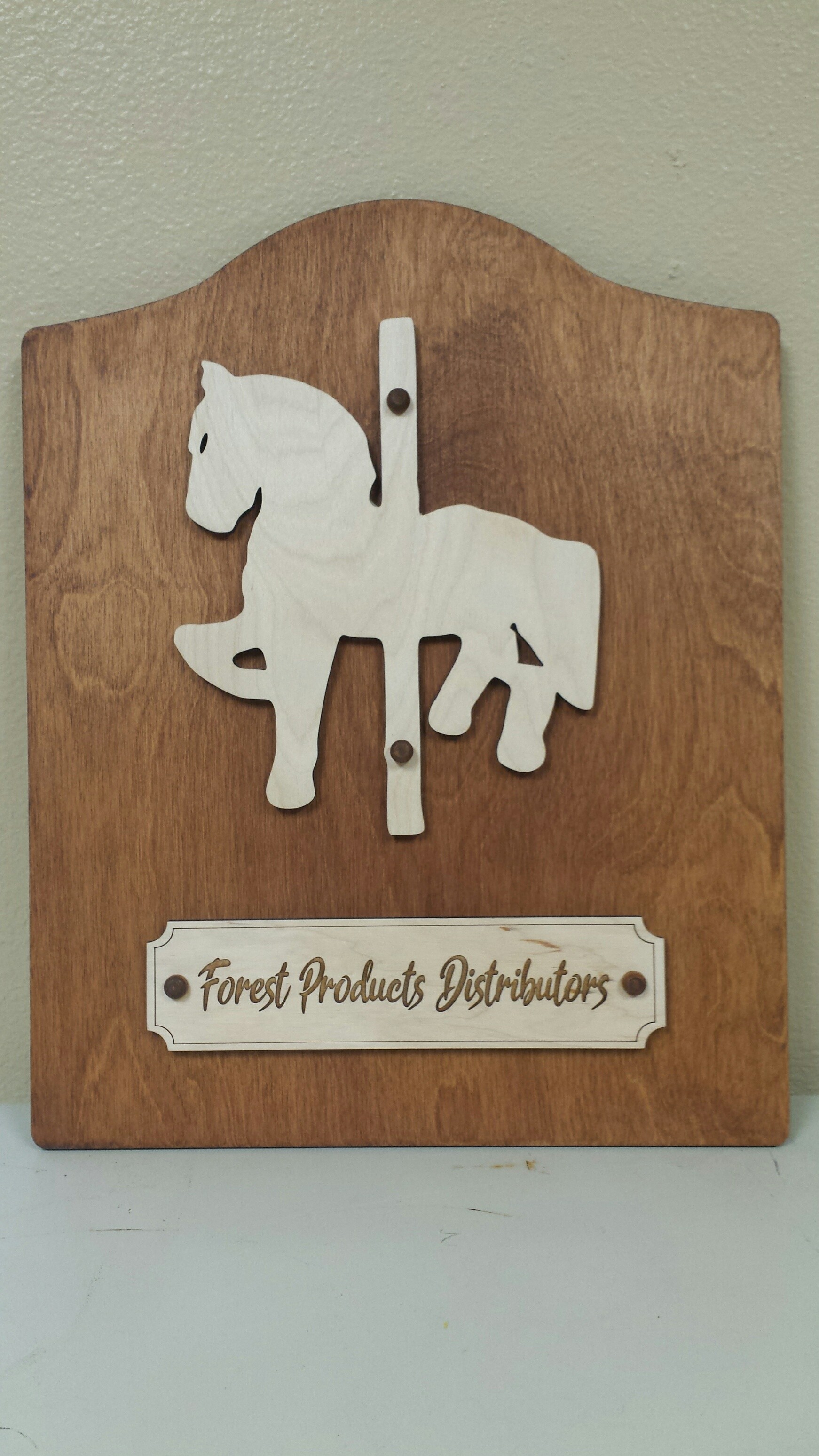 Wooden donor plaque with a layered carousel horse and engraved nameplate